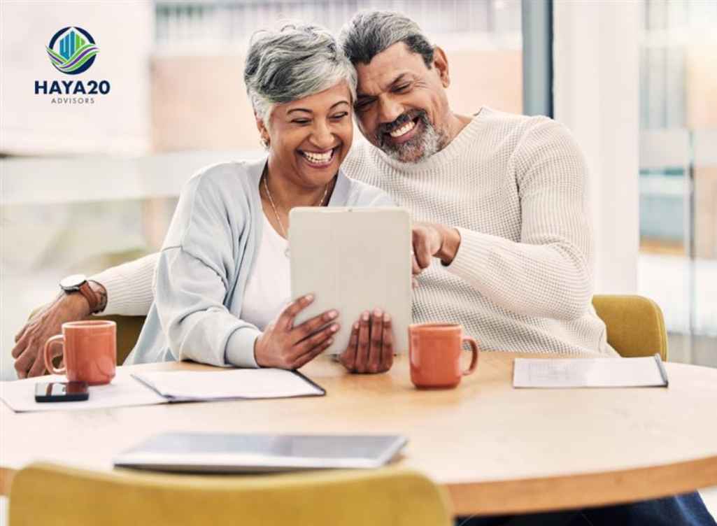 Retired couple using a tablet to review their retirement plan and life insurance strategy for long-term financial security.