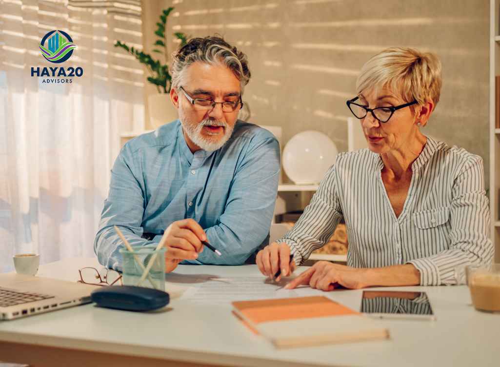 Couple reviewing retirement income options with financial documents.