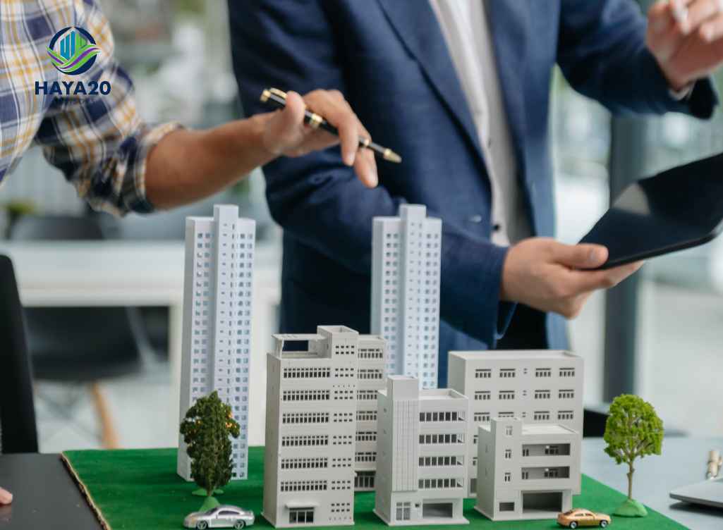 Professionals reviewing a commercial real estate model and discussing property investment.