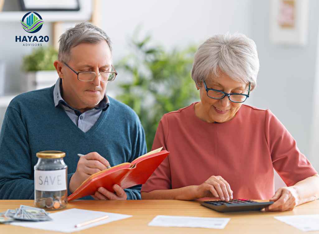 Retired couple reviewing savings and calculating finances for Roth conversion planning.