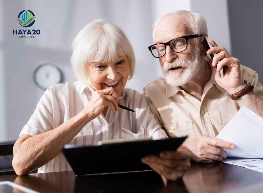 Older couple discussing Social Security claiming options and reviewing financial documents.