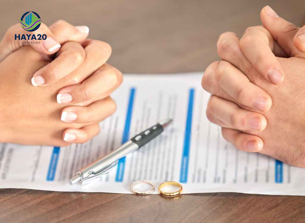Couple reviewing financial documents with wedding rings on the table.