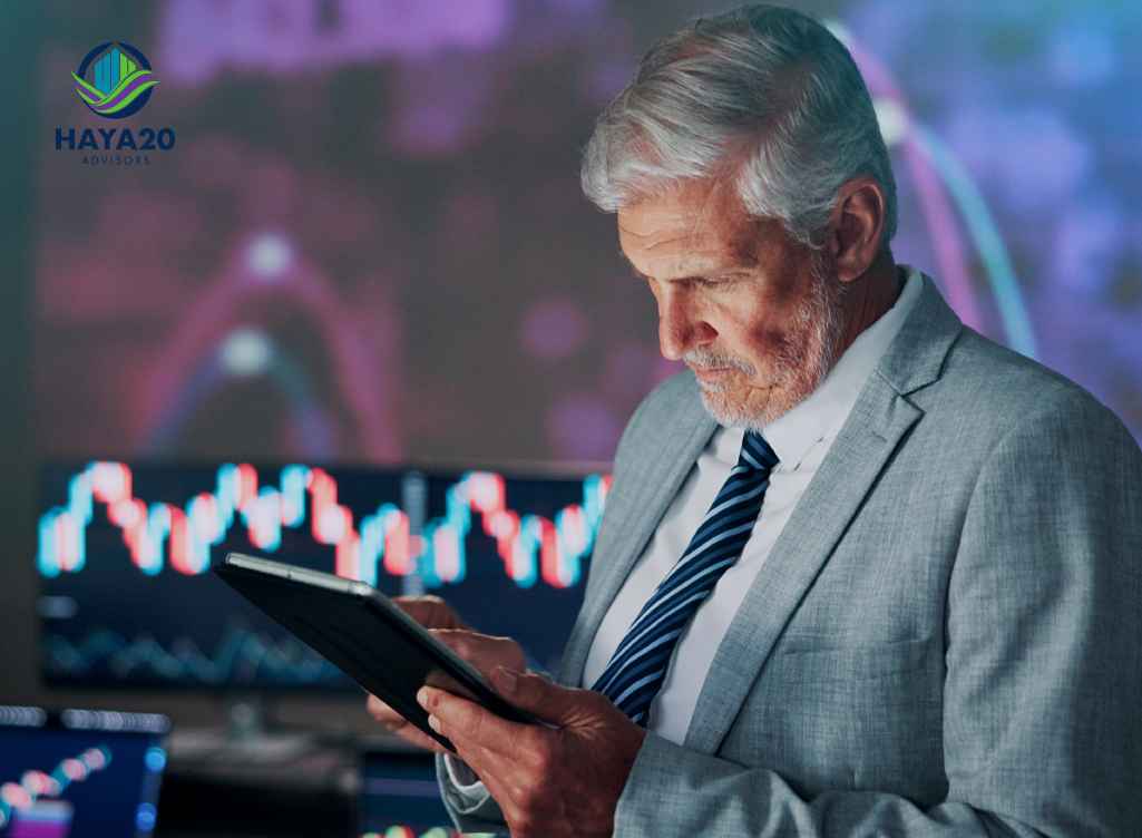 Senior investor analysing stock market charts on a tablet.